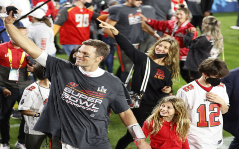 Moms Proud Hug: Celebrating Sons Football Game Success